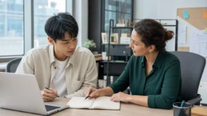 Realistic editorial photograph of an international university student planning learning goals during an internship